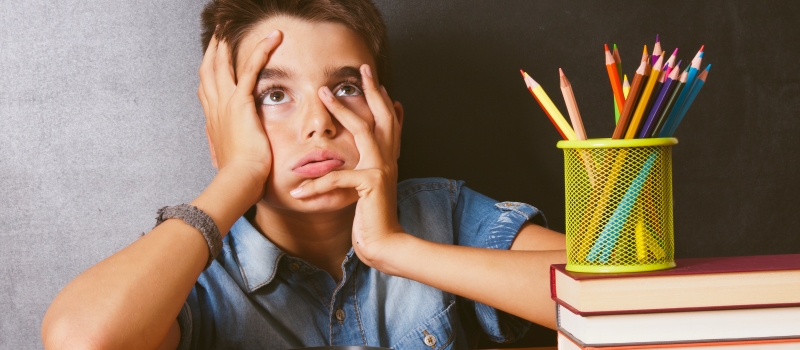 boy with bored expression at school